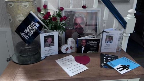 A table display of photographs set up by somebody to remember their loved one.