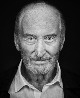 Charles Dance in black and white looking at the camera