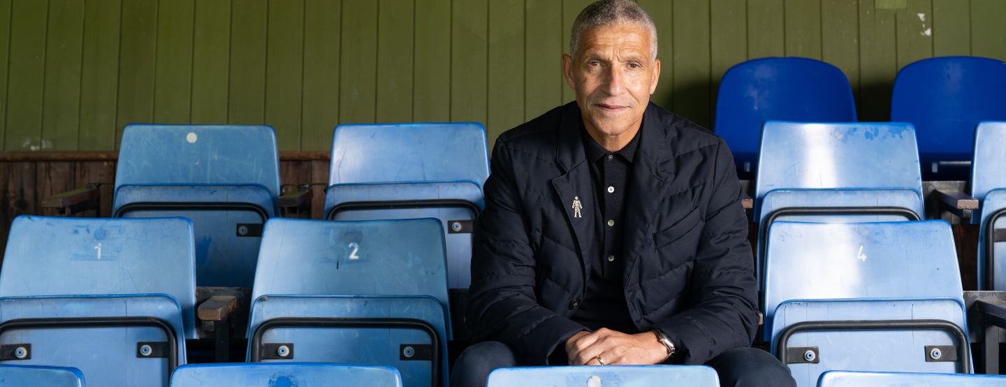 202604 Chris Hughton In Stands With Man Of Men Bagde