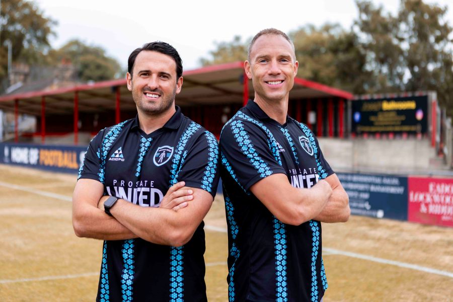 Stephen and his colleague Ross posing in Prostate United shirts.
