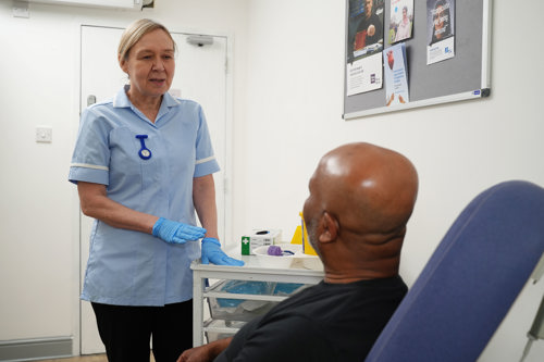 A nurse speaking to a patient.