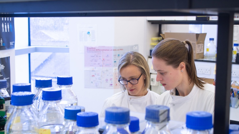 Kelly Coffey Behind Some Bottles