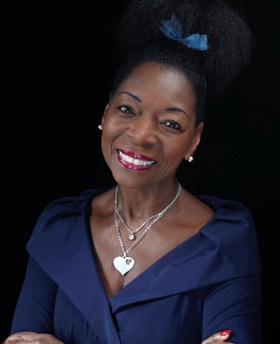 Floella Benjamin wearing a navy blue top and smiling