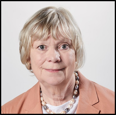 A woman with short hair wearing an orange jacket