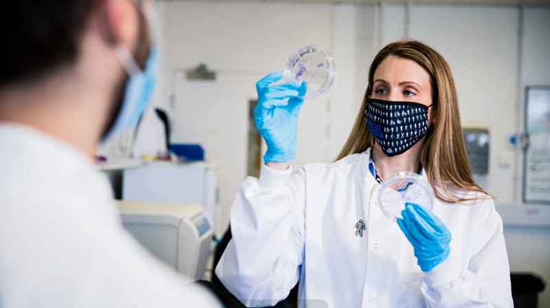 Jenny Munkley Showing Petri Dish To Volunteer