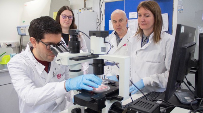 Helen Pearson And Team Use Microscope