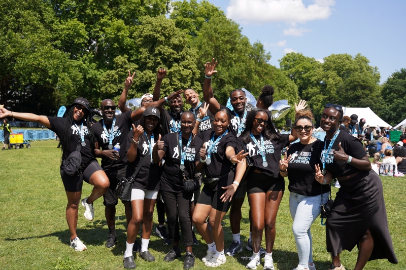A group of black people smiling and cheering at March for Men.