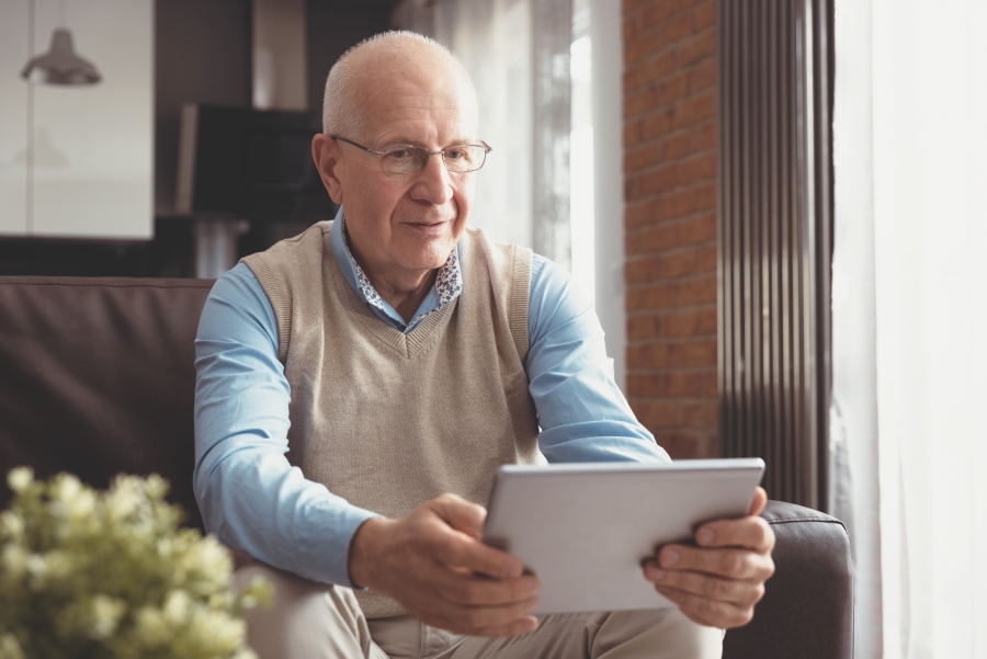 A man watching something on a tablet.